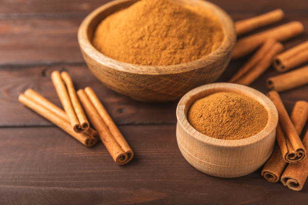 istock Cinnamon powder  on a textured wooden background. Spicy spice for baking, desserts and drinks. Fragrant ground cinnamon. Cinnamon stick. Place for text. Copy space. 2150522913