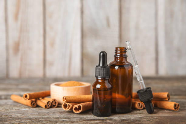 istock Cinnamon aromatic essential oil and cinnamon sticks on  background. Aromatherapy. Organic cosmetic oil. Spa concept. Place for text. Copy space. 2150522965