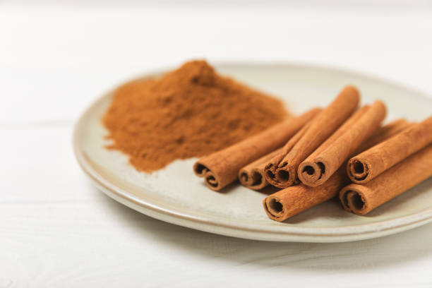Cinnamon sticks on background. Cinnamon roll. Spicy spice for baking, desserts and drinks. Fragrant ground cinnamon. cinnamon powder Close-up. Place for text. copy space