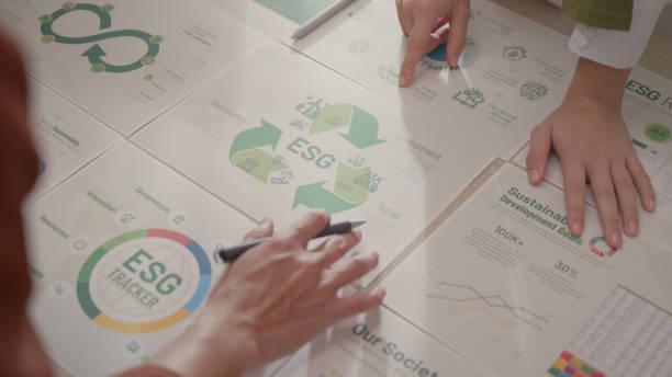 istock Hands Pointing at ESG Components During Sustainability Meeting. 2150523305