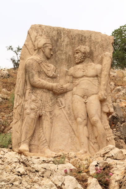 istock Relief depicting a handshake between King Mithridates, Antiochus I of Commagene and Heracles, at Site III at the ancient site of Arsameia on the Nymphaios, close to Adiyaman, Turkey 2150523317