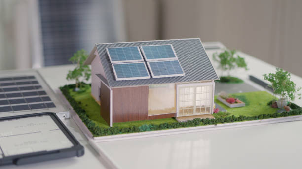 A detailed architectural model displays a modern house equipped with solar panels, highlighting sustainable living and renewable energy integration in home design.