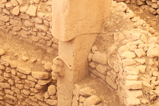 Pillar 27 in Enclosure C at the neolithic archaeological site of Göbekli Tepe, Potbelly Hill, showing a predator or cat on a t-shaped pillar hunting a boar, close to Sanliurfa, Turkey 2022