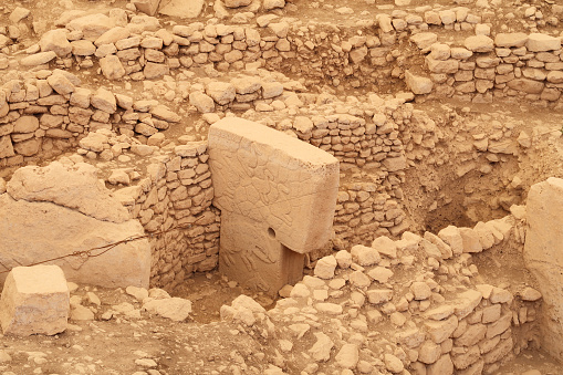 Pillar 12 in Enclosure C at the neolithic archaeological site of Göbekli Tepe, Potbelly Hill, a t-shaped pillar showing ducks and a boar, close to Sanliurfa, Turkey 2022