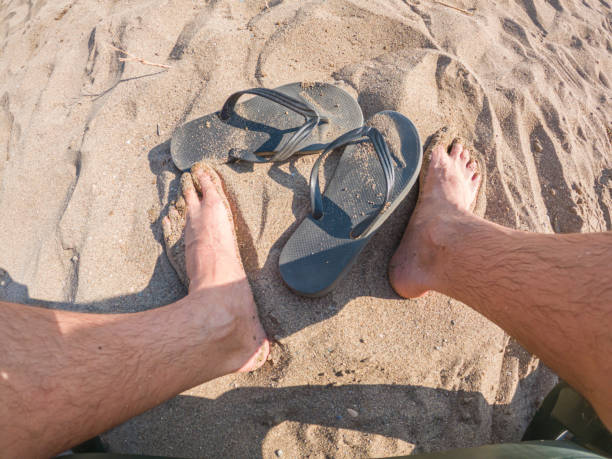 young man in sandals after a long trip stopped for a rest