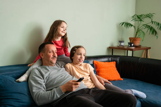 istock Family watching tv at home 2150527333
