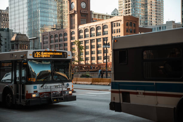 Cta Bus - Details of the city of Chicago. Cars, residents, and tourists, life in a big city, panoramic city views, everyday life. Historical landmarks, tourist destinations - Stock Photo In the USA, Chicago, Illinois features the Chicago River, glass and steel buildings, with skyscrapers in the background, and downtown riverside, representing concepts of business, modern transportation, the financial district, the construction industry, business enterprise organization, and communication technology - The Chicago Loop boris bus stock pictures, royalty-free photos & images