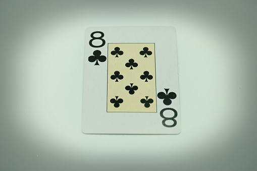 Poker cards on a playing green table with chips.