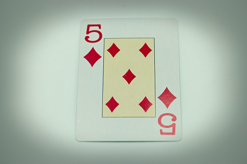 Five of Diamonds. Isolated on a gray background. Gamble. Playing cards. Cards.