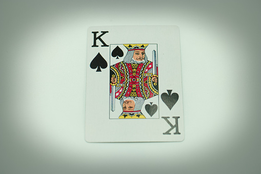 Oslo, Norway - June 4, 2015: Vintage playing card with illustration of colourful,blue, red and yellow joker with jester hat.