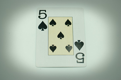Ace of hearts playing card, isolated on black background.