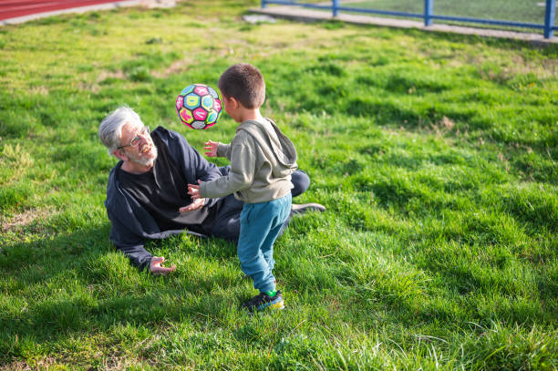istock Family Playtime: Toddler's Soccer Bond with Grandfather 2150529462
