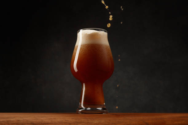 istock Full Pint Of Dark Beer With Falling Drops on a bar counter. 2150529612