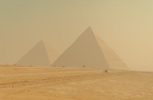 Pyramids of Giza in golden hazy morning light