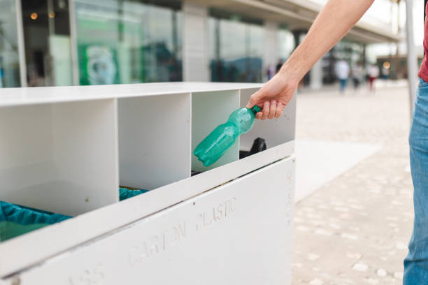 istock Close up of human hand throwing away a plastic bottle 2150532177