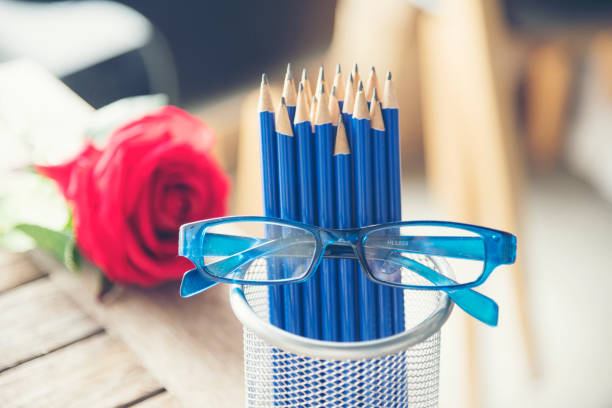 Close-up of table with colored pencils and cookie bowl