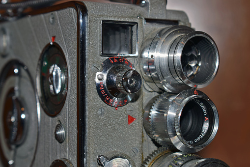 Vintage movie camera on a gray background.