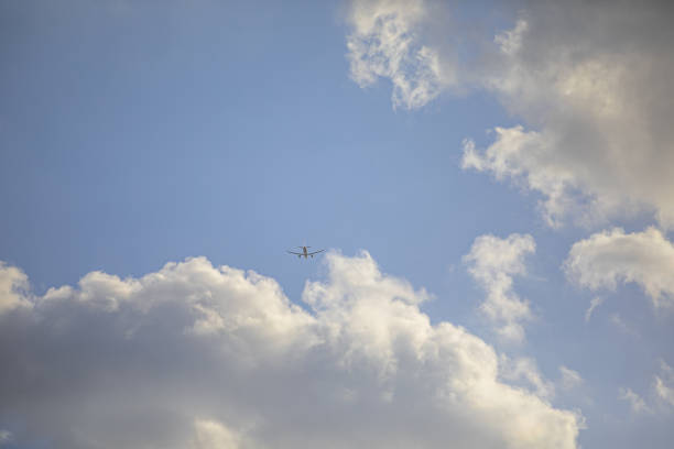 Commercial jet flying over clouds