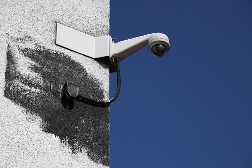 CCTV camera on white wall