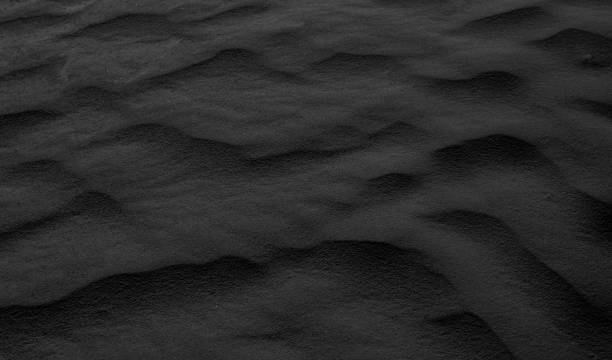 istock black desert sand shaped into waves by the wind 2150535322