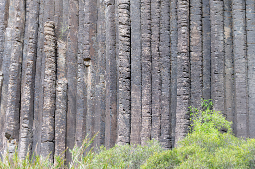 Hexagonal basalt rock columns formation. In Organ Pipes national park, Victorai Australia