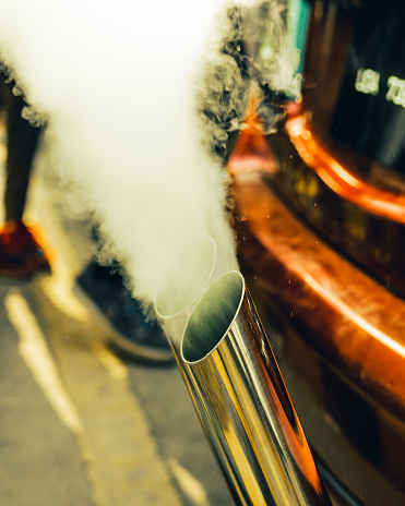 Capture the smoke emerging from a sports car's exhaust.