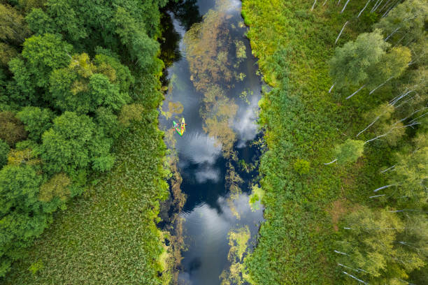 istock tourists kayaking on a small meandering river (aerial view) 2150543874