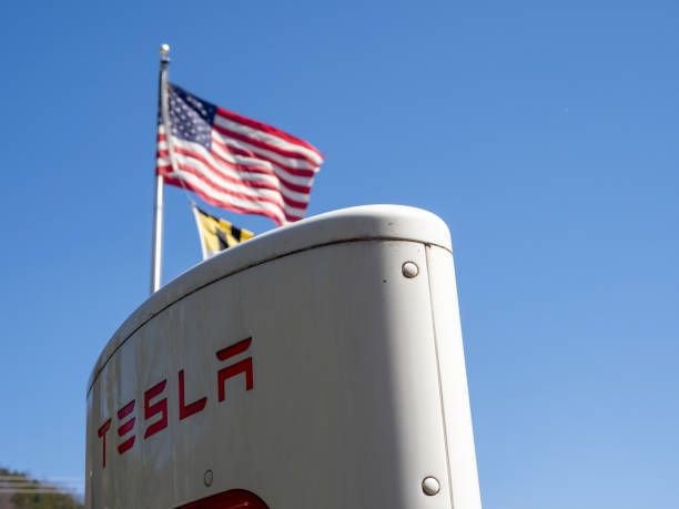 La Vale Maryland USA-03 29 2024: Tesla Supercharger with American flag and blue sky in La Vale Maryland, USA. stock photo