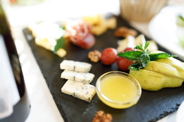 Cheese plate. Gorgonzola, hard cheese, grapes, honey, nuts