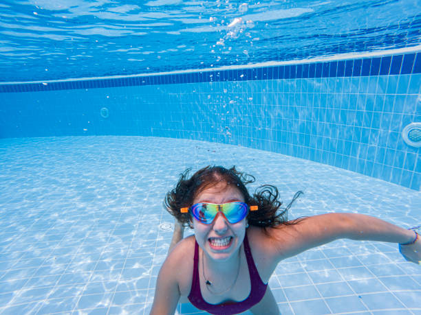 istock Little girl having fun swimming underwater 2150546763