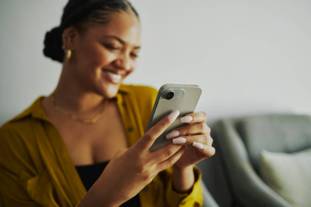 istock Happy Woman Texting on Mobile Phone at Home/Office 2150548518