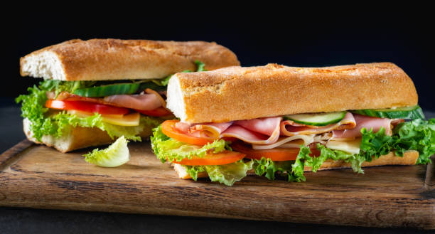 istock Two big sandwich with lettuce tomatoes prosciutto cucumber and cheese 2150549206