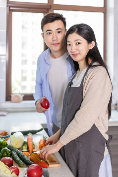 istock Young Oriental couple in the kitchen 2150549890