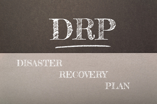 A chalkboard with the words Disaster Recovery Plan written on it. The words are in white and the background is in black