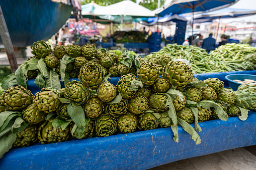 artichokes are in showcase at bazaar focus on foreground horizontal still