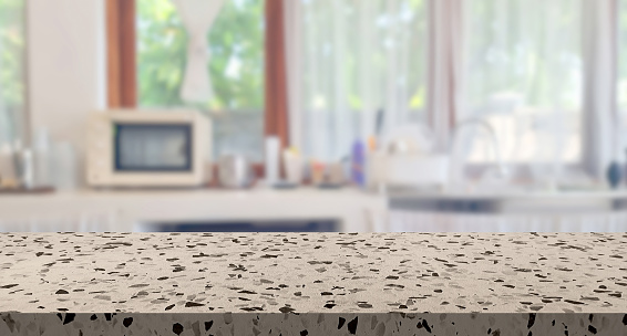 beige brown terrazzo stone table top on blur cafe minimal kitchen counter at background in bright color mood and tone for montage product display or design key visual layout. empty table space.