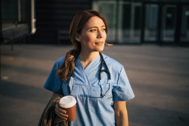 istock Beautiful attractive female doctor on morning shift on coffee break. 2150554802