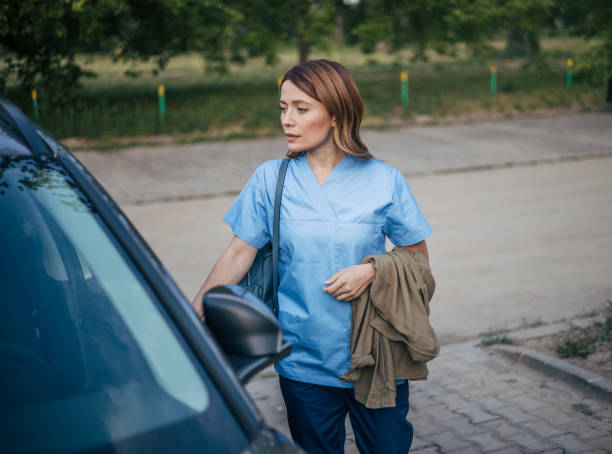 istock Female doctor driving car to work 2150556073