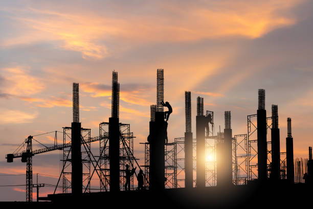 istock Silhouette of Engineer and worker on building site, foreman worker and builders checking project at construction site 2150558995