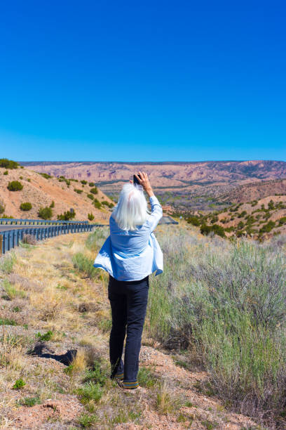 Chimayo, NM: Tourist Photographing Desert Landscape Roadside