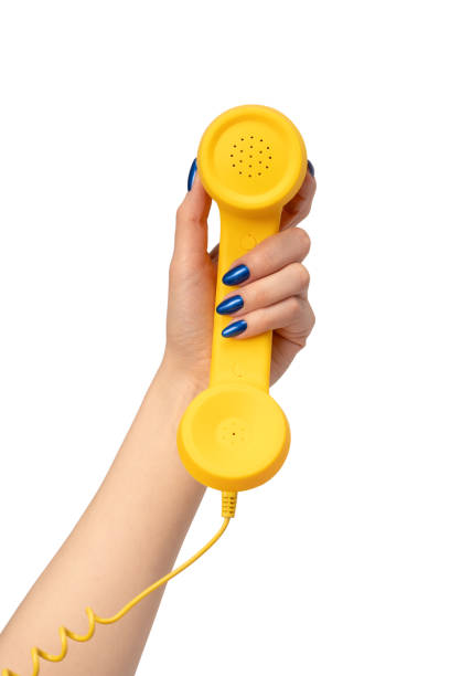 istock Yellow handset in woman hand isolated on white. Copy space. 2150563954