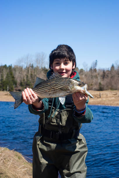 istock A young fisher out on the river 2150564900