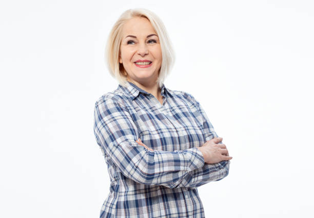 Attractive middle aged woman with folded arms isolated on white background