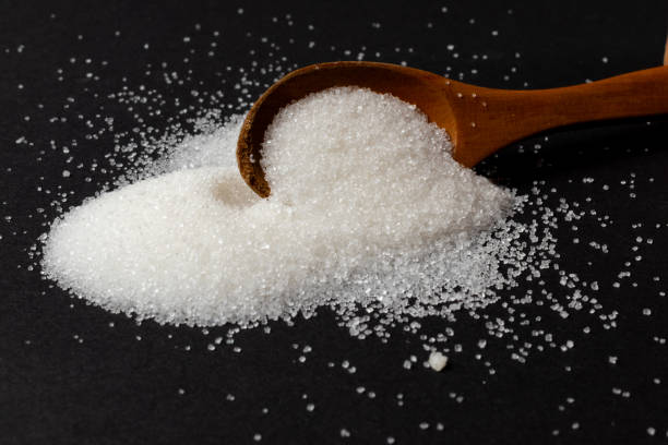 istock White sugar and wooden spoon 2150567664