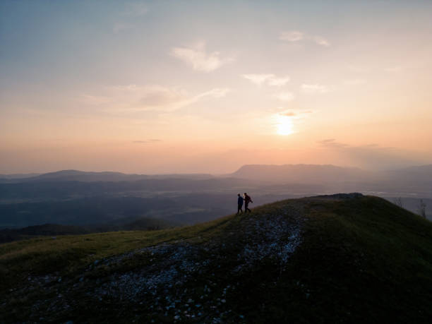 The most beautiful summit cross in the Alps at sunrise - Aerial view of Nationalpark Berchtesgaden with Watzmann in background