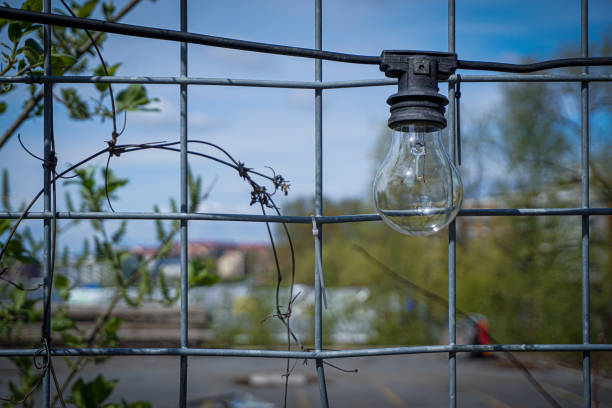 istock a light bulb hangs on the fence 2150571151