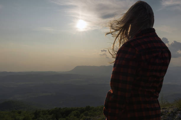 Young woman hiker walking and looking at beautiful nature view