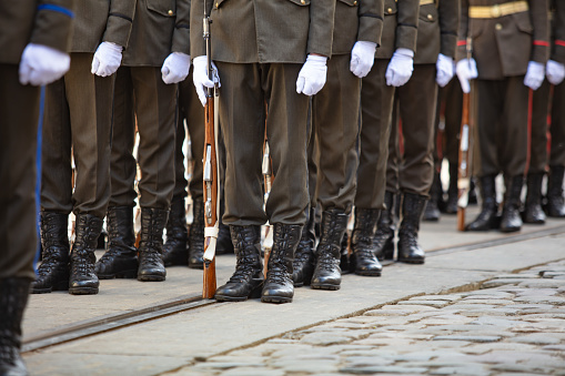 Closeup of soldiers legs and guns for design purpose