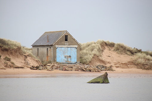 The old boatshed and sunken boat, Ythan Estuary, Newburgh, Aberdeenshire, Scotland