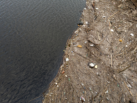 Rubbish floating on the River Clyde in Glasgow polluting the water UK